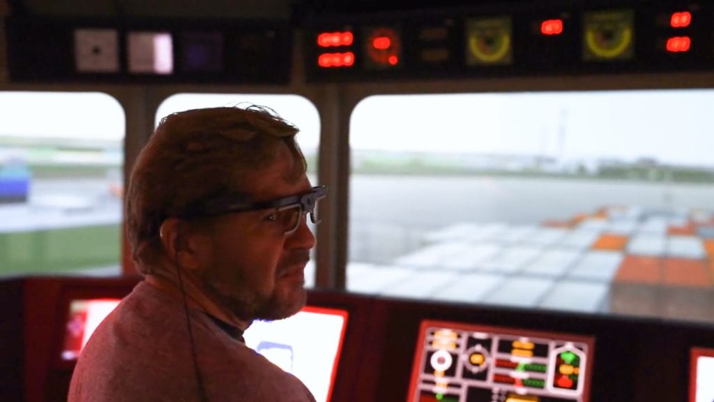 man with eye tracking glasses in an airplane simulator cabin