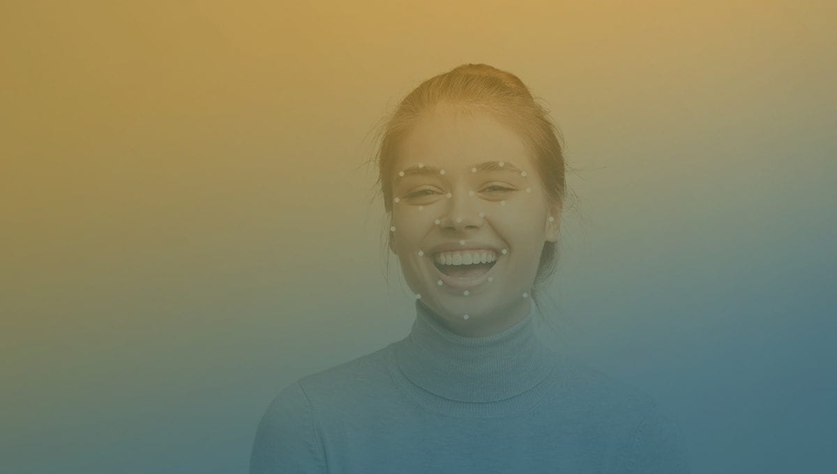 Facial Expression Analysis Woman on a bench in a park holding a smartphone with facial expression analysis grid on her face