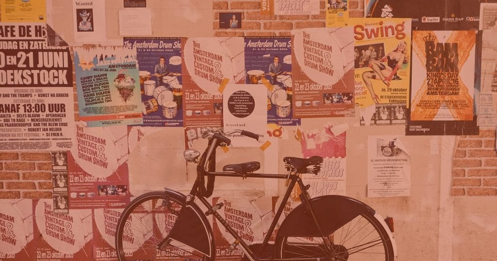 Bike in front of bulletin board with posters