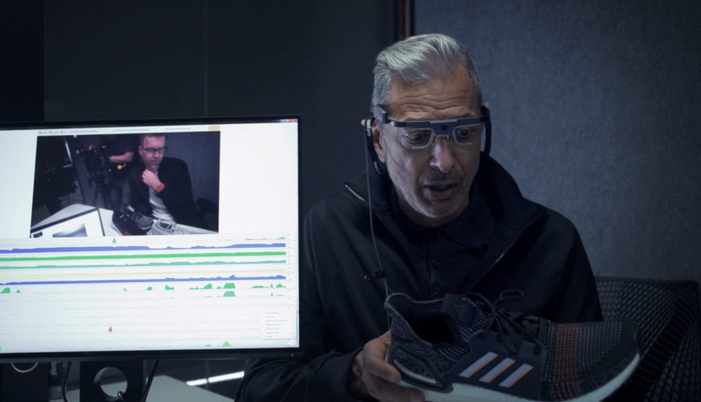 Jeff Goldblum wearing eye tracking glasses looking at a sneaker