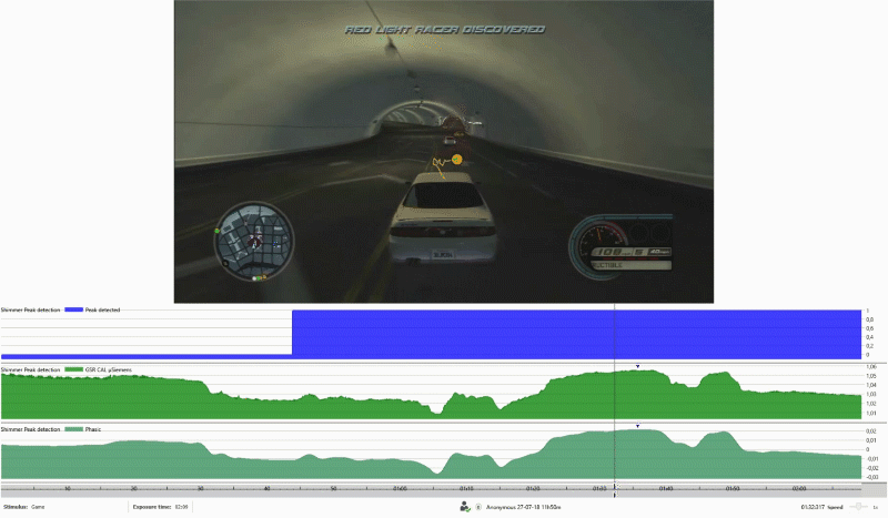 video of a screen displaying a video game of a racing car and an emotional measurement graph