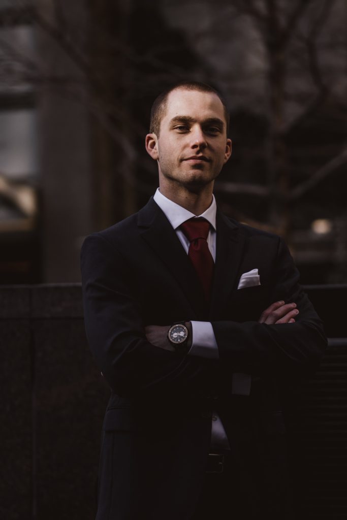 man in business suit with arms crossed looking at camera