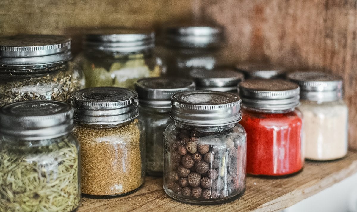 jars filled with various spices placed on a shelf