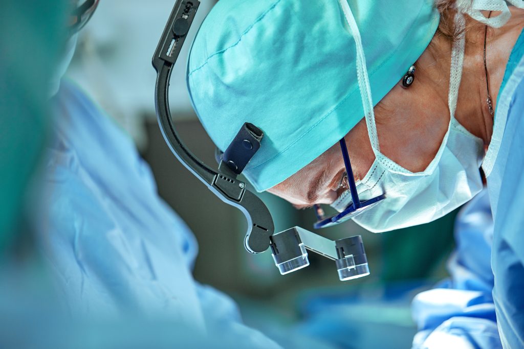 Surgeon in operation room with reflection in glasses