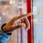 Finger pointing at a large display in public